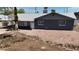 A single-story home with a gray roof and inviting front yard landscaping with rock ground cover at 1027 S Lola Ln, Tempe, AZ 85281