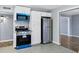 Updated kitchen with stainless steel appliances and white cabinets at 1027 S Lola Ln, Tempe, AZ 85281