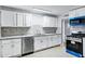 Well-lit kitchen with marble counters, white cabinets and tiled backsplash at 1027 S Lola Ln, Tempe, AZ 85281