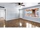 Light-filled living room featuring wood floors, a ceiling fan, and a large window at 1027 S Lola Ln, Tempe, AZ 85281