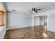 Spacious living room with wood flooring, gray walls, and a ceiling fan fixture at 1027 S Lola Ln, Tempe, AZ 85281