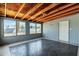 Bright sunroom with herringbone tile floors, wood ceiling, and view to the backyard through large windows at 1027 S Lola Ln, Tempe, AZ 85281