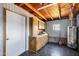 Finished utility room with cabinets, water heater, and painted paneling walls at 1027 S Lola Ln, Tempe, AZ 85281
