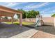Backyard features a play structure, covered patio, and is ready for entertaining guests at 1028 W Chilton Ave, Gilbert, AZ 85233
