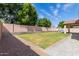 Large backyard with a play structure for the and lush green grass at 1028 W Chilton Ave, Gilbert, AZ 85233