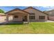 Spacious backyard with a covered patio and lush green lawn, perfect for outdoor entertaining at 1028 W Chilton Ave, Gilbert, AZ 85233