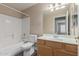 Cozy bathroom featuring a shower-tub combo and a vanity with plenty of storage at 1028 W Chilton Ave, Gilbert, AZ 85233