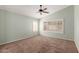 A spacious, carpeted bedroom with shuttered windows and a modern ceiling fan at 1028 W Chilton Ave, Gilbert, AZ 85233