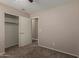 Neutral bedroom featuring plush carpeting, walk-in closet, ceiling fan, and modern design at 1028 W Chilton Ave, Gilbert, AZ 85233