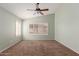 A spacious, carpeted bedroom with shuttered windows and a modern ceiling fan at 1028 W Chilton Ave, Gilbert, AZ 85233