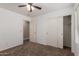 Bright bedroom with carpet, fan, window with blinds, and a closet providing ample storage at 1028 W Chilton Ave, Gilbert, AZ 85233