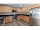 Well-lit kitchen featuring wood cabinets, stainless steel appliances, and granite countertops at 1028 W Chilton Ave, Gilbert, AZ 85233