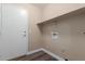 Well-lit laundry room with utility connections, shelf, and white trim at 1028 W Chilton Ave, Gilbert, AZ 85233