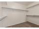 Walk-in closet with carpeted floor and white racks and shelves at 1028 W Chilton Ave, Gilbert, AZ 85233