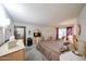 Bedroom with a large bed, neutral carpet, walk-in closet, dresser, and an exterior view at 10401 W Loma Blanca Dr, Sun City, AZ 85351