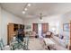 A large living room with multiple sofas, a glass top dining table, and a sliding door to the outside at 10401 W Loma Blanca Dr, Sun City, AZ 85351