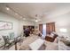 Comfortable living room with a glass top dining table, sofa, ceiling fan, and sliding glass door at 10401 W Loma Blanca Dr, Sun City, AZ 85351