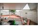 Covered patio with a brick border, a white brick wall, and a view of the landscaped yard at 10401 W Loma Blanca Dr, Sun City, AZ 85351