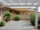 Private back patio with a pergola and decorative brick wall and mature plants at 10428 W Camelot Cir, Sun City, AZ 85351