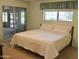 Cozy bedroom featuring a queen size bed and an attached sunroom with sliding glass doors at 10428 W Camelot Cir, Sun City, AZ 85351