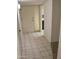 Entryway with tiled floor, white walls and view into the kitchen at 10428 W Camelot Cir, Sun City, AZ 85351