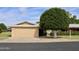 Charming single-story home with mature landscaping and a two-car garage at 10428 W Camelot Cir, Sun City, AZ 85351