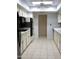 Well-lit kitchen features white cabinets, tile floors, and modern appliances at 10428 W Camelot Cir, Sun City, AZ 85351