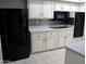 Updated kitchen with white cabinets, stainless steel appliances, and stylish backsplash at 10428 W Camelot Cir, Sun City, AZ 85351