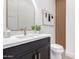 Stylish powder room with modern vanity, beautiful fixtures, and artistic wall decor at 11662 E Parkview Ln, Scottsdale, AZ 85255