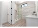 Elegant bathroom with seamless glass shower, mosaic tile accents, and white marble countertop at 11662 E Parkview Ln, Scottsdale, AZ 85255