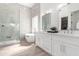 Bright bathroom with double sinks, freestanding tub, and glass-enclosed shower featuring sleek design at 11662 E Parkview Ln, Scottsdale, AZ 85255