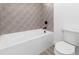 Clean, modern bathroom featuring a shower-tub combo with unique tiling and sleek black fixtures at 11662 E Parkview Ln, Scottsdale, AZ 85255