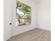 Minimalist bedroom featuring a large window that looks out on lush greenery and a tiled floor at 11662 E Parkview Ln, Scottsdale, AZ 85255