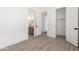 Bright bedroom with wood-look tile, closet and bathroom access, creating a serene and accessible space at 11662 E Parkview Ln, Scottsdale, AZ 85255