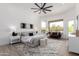 Spacious bedroom with ceiling fan, view windows, seating area, and plush rug for comfort at 11662 E Parkview Ln, Scottsdale, AZ 85255