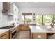 Bright kitchen with an island and bar seating, stainless steel appliances, and ample counter space at 11662 E Parkview Ln, Scottsdale, AZ 85255