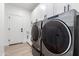 Well-equipped laundry room features modern washer and dryer and ample storage at 11662 E Parkview Ln, Scottsdale, AZ 85255