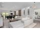 Open-concept living space with a sectional sofa, adjoining dining area, and stylish decor, perfect for modern living at 11662 E Parkview Ln, Scottsdale, AZ 85255