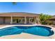 Backyard view of a sparkling blue pool and covered patio surrounded by lush landscaping at 11662 E Parkview Ln, Scottsdale, AZ 85255