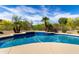 Sparkling pool with blue tile, rock features, waterfall, and desert landscaping at 11662 E Parkview Ln, Scottsdale, AZ 85255