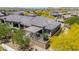 Aerial view of a landscaped backyard with patio, desert landscaping, and tile-roofed homes in a community at 12325 S 179Th S Ave # 0, Goodyear, AZ 85338