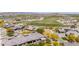 Aerial view of a residential area featuring golf course and desert surroundings, with tile roofs at 12325 S 179Th S Ave # 0, Goodyear, AZ 85338
