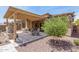 The backyard patio offers ample seating and dining space under a pergola with lovely landscaping at 12325 S 179Th S Ave # 0, Goodyear, AZ 85338