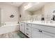 Bathroom with double sinks, soaking tub, and walk-in shower at 12325 S 179Th S Ave # 0, Goodyear, AZ 85338