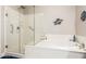 Bathroom with glass-enclosed shower and soaking tub at 12325 S 179Th S Ave # 0, Goodyear, AZ 85338