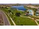 Aerial view of a community lake and pool area with a large green space and palm-lined streets at 12325 S 179Th S Ave # 0, Goodyear, AZ 85338