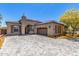 Beautiful single-story home with stone paver driveway and three-car garage in a well manicured yard at 12325 S 179Th S Ave # 0, Goodyear, AZ 85338