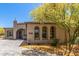 Attractive home front with desert landscaping, paver driveway, arched windows, and inviting curb appeal at 12325 S 179Th S Ave # 0, Goodyear, AZ 85338