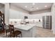 Bright kitchen with white cabinets, marble countertops, and stainless steel appliances and hardwood floors at 12325 S 179Th S Ave # 0, Goodyear, AZ 85338