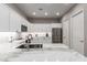 Modern kitchen featuring white cabinets, stainless steel appliances, and a marble countertop island at 12325 S 179Th S Ave # 0, Goodyear, AZ 85338